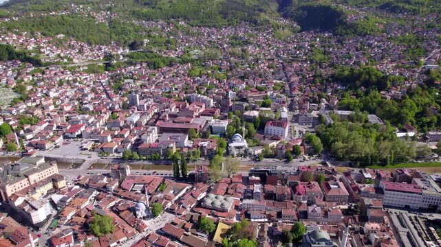 Drone panorama backdrop of historic Sarajevo center surrounded by densely built hillside districts, aerial, Bosnia and Herzegovina