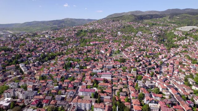 Sarajevo neighborhoods stretching through a broad mountain valley, aerial panoramic overview, Bosnia and Herzegovina