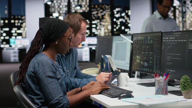 Tech startup colleagues brainstorming ways to optimize performance in office. Programmers use advanced machine learning APIs for debugging, typing lines of code for coding workflows.