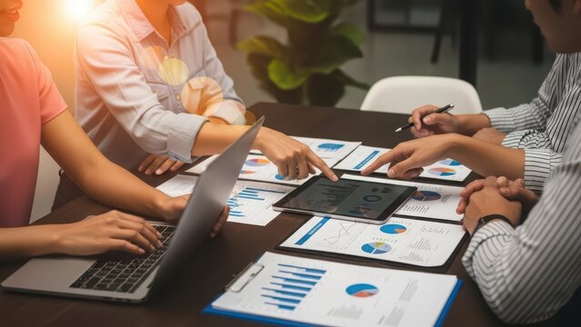 Business meeting with colleagues analyzing data and reports