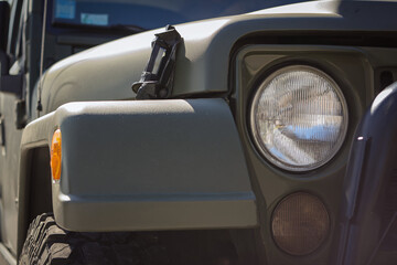 Fototapeta premium Close-up of a rugged SUV with an olive-green exterior and strong features.