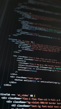 Lines of software code display on a dark computer screen with colorful syntax highlighting. The script shows logic for artificial intelligence functions and web application development.