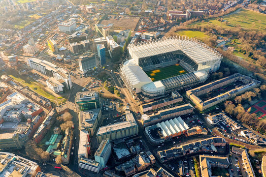 Aerial drone view of St James Park, Newcastle United stadium, asymmetric stands dominating Newcastle city centre, Newcastle upon Tyne, England, UK