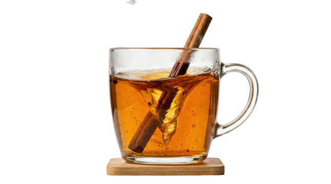 A clear glass mug filled with hot herbal tea and a brown cinnamon stick resting on a small wooden coaster for a cozy warm beverage concept