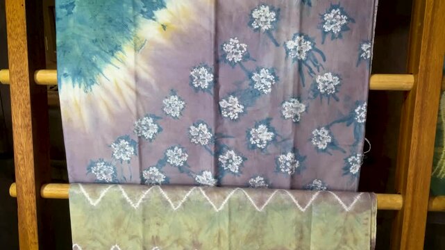 Colorful Traditional Tie Dye Fabric Displayed on Wooden 
Rack in Artisan Textile Workshop Borneo Indonesia