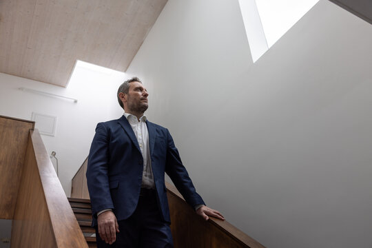 Businessman walking down stairs in a contemporary office