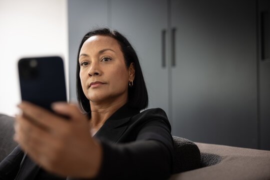 Businesswoman making financial investments using a smartphone