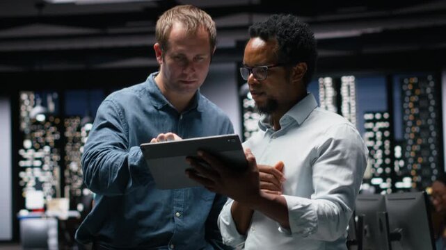 Engineers developing AI algorithms in modern high rise office. IT experts debug apps while visualizing 3D neural network brain models on glowing screens.