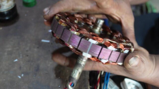 Electric motor stator repair with skilled technician