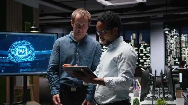 Programmers in office analyzing machine learning algorithms to prevent AI model errors. Colleagues reviewing code logic to improve artificial intelligence prediction accuracy for coding workflows.