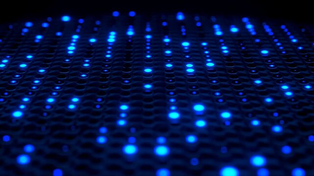Glowing orange lights on a dark perforated surface