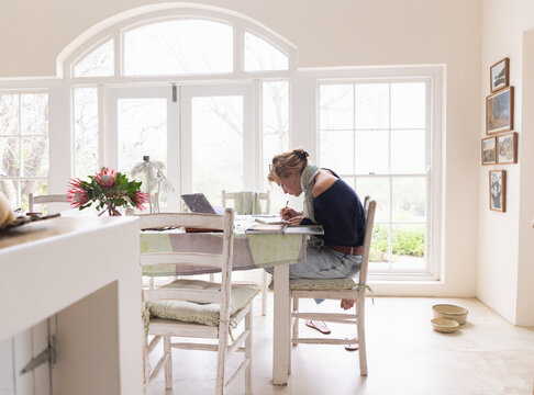 20 year old woman artist working on a drawing in her studio