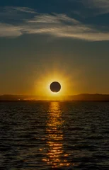 Fotobehang Zonsondergang Zee Total solar eclipse over a coastal lagoon at sunset with a spectacular reflection of the sun in the water in the Albufera of Valencia, Spain.  © sirbouman
