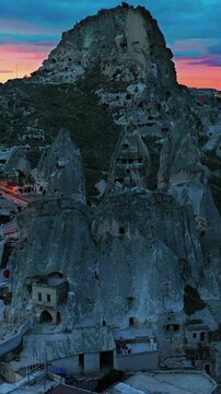 Drone view of Ortahisar Castle towering above the historic town of Ortahisar in Cappadocia, Turkey. A remarkable example of rock-carved architecture.