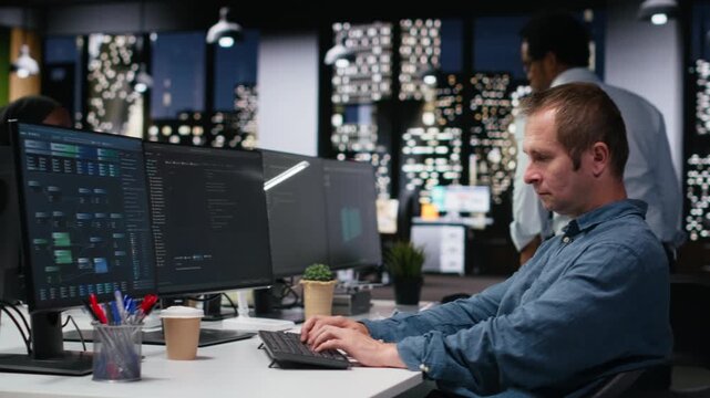 Admin in office waiting for code to finish compiling, developing machine learning models to automate tasks with coding and programming workflow.