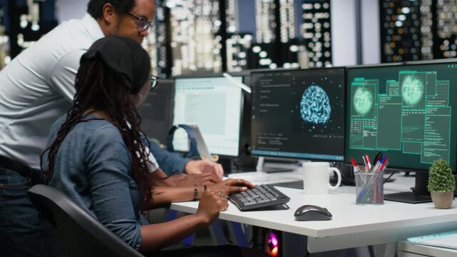 Team of programmers in office working together to block hacker intrusion. Teamworking IT company cybersecurity division colleagues coordinating incident response for scammer attacks.