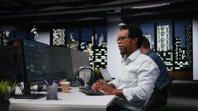 Software developer in workplace doing AI tech quality assurance. IT startup employee in office typing on keyboard, writing AI script with programming languages.