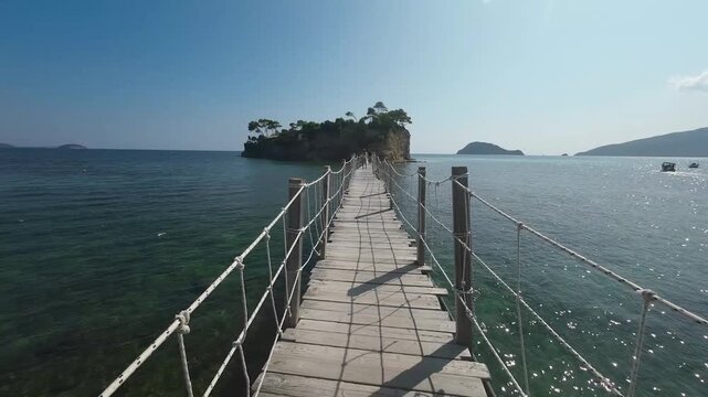 Walking on bridge to Cameo Island Zakynthos, Greece. Sea and coast with sandy beach. Summer destination on the Mediterranean Sea, Europe

