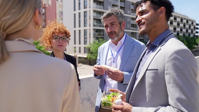 Professional business colleagues discussing work during lunch break