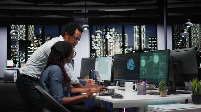 Team of programmers in office working together to block hacker intrusion. Teamworking IT company cybersecurity division colleagues coordinating incident response for scammer attacks.