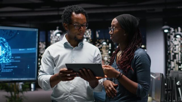 Engineering team in office analyzing machine learning algorithms to prevent AI errors. Coworkers talking, brainstorming how to improve artificial intelligence prediction accuracy for coding workflows.