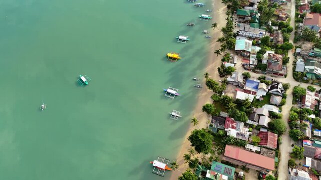 Flyover aerial shot of Port Barton coast in San Vicente, Philippines