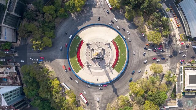 Top down aerial timelapse of the &Aacute;ngel de la Independencia in Mexico City, showing circular traffic flow and urban symmetry from a static drone perspective.