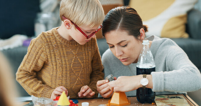 Mother, boy and science experiment in home with cola, bonding or teaching skill for child development. Woman, son and scientific project in house with fizzy drink, equipment and learning for growth.