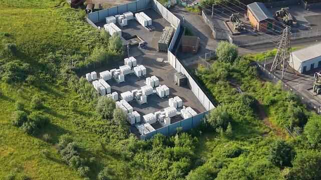 Small BESS Battery Energy Storage System with Modular Lithium-ion Containers. Smart grid management, AI energy optimization, and sustainable infrastructure. Filmed in UK. 4K.