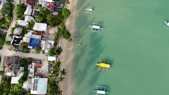 Flyover aerial shot of Port Barton coast in San Vicente, Philippines