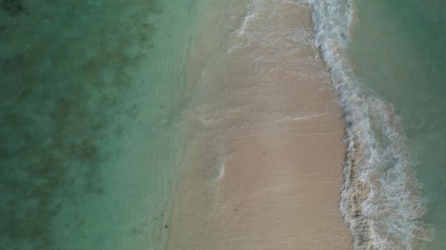 Spectacular top down drone footage famous sandbar at Cayo de Agua Los Roques Archipelago. Reveal unique sand formation connecting island beaches, one of the most iconic natural caribbean attractions