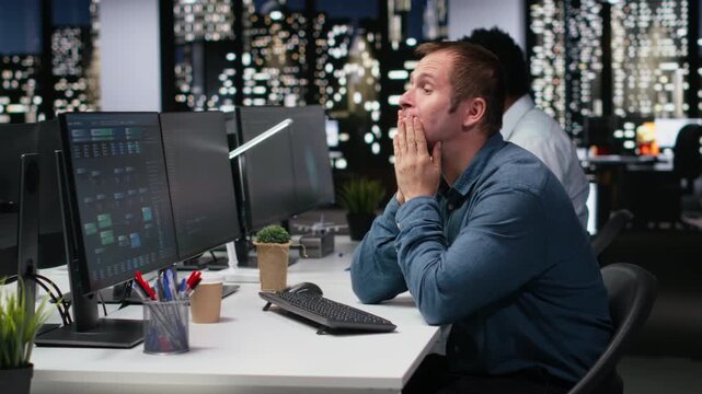 Stressed man in company workplace worried by glitches while doing artificial intelligence tech quality assurance. Anxious admin in office struggling with AI programming languages script.