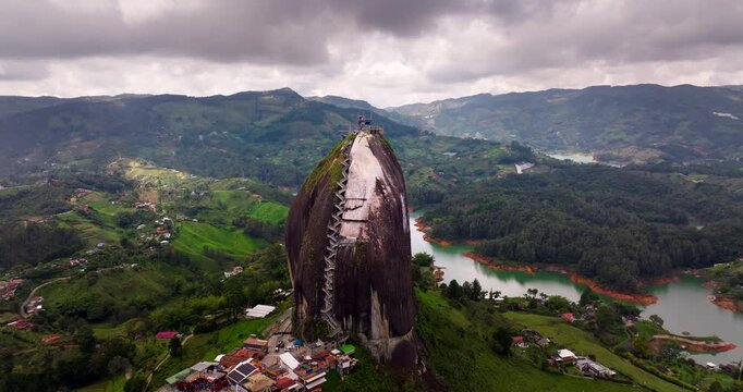 Drone pullback view of iconic attraction La Piedra Del Penol in Guatap&eacute; Colombia