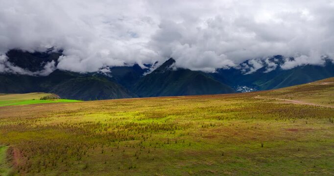 Fertile meadow of Maras district in Sacred Valley with thick mountain fog. Drone