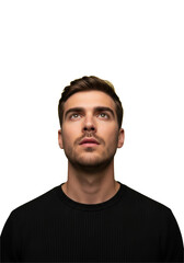 Fototapeta premium young caucasian man in a black shirt intently gazing upwards into vibrant yellow copy space, detailed portrait with dramatic high-key light against a gray background. concept of focused attention and