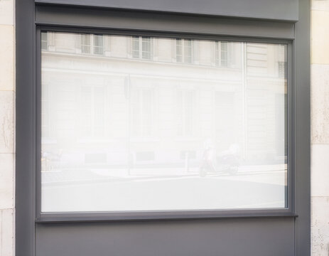 Blank white wall poster frame mockup template on storefront window