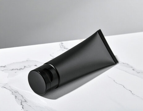 Black skincare tube mockup template on white marble surface