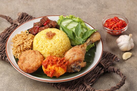 Nasi Kuning. Yellow rice is a typical Indonesian food. This food is made from rice cooked with turmeric, coconut milk and spices