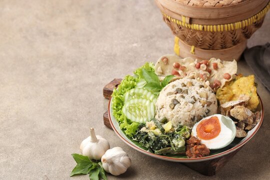 Nasi Megono, a signature dish from Central Java, Indonesia, featuring steamed rice topped with finely chopped young jackfruit mixed with grated coconut and aromatic spices