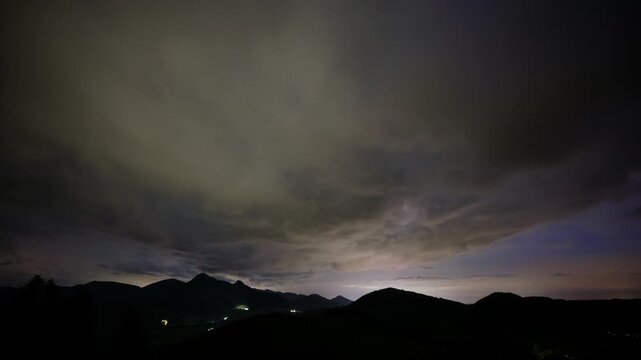 Night Sky Timelapse with Moving Clouds Over Mountain Silhouette