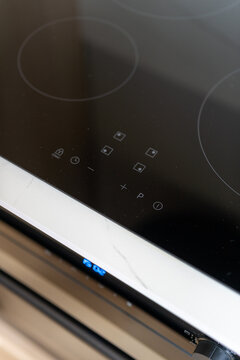 Close up shot of induction hob with sleek glass ceramic touch controls