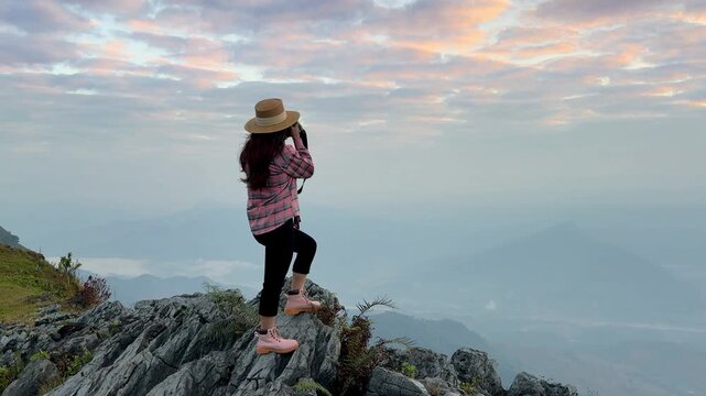 Tourists take photos and enjoy the panoramic natural scenery at Doi Pha Mon, Chiang Rai Province, Thailand.