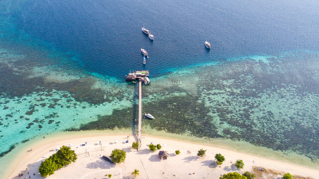 Aerial View of a Long Wooden Jetty and Boats at a Tropical Island Resort