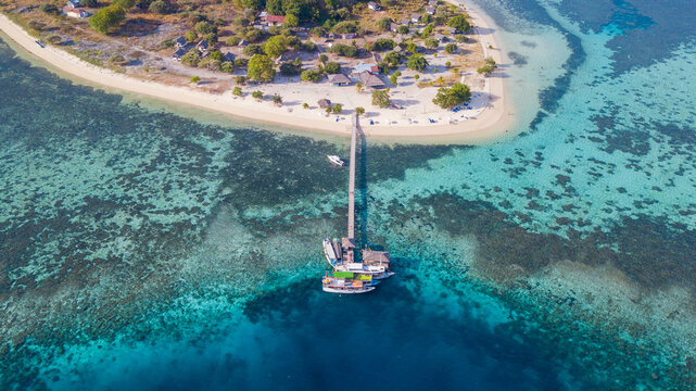 Aerial View of Kanawa Island Resort with Wooden Jetty and Coral Reef, Indonesia
