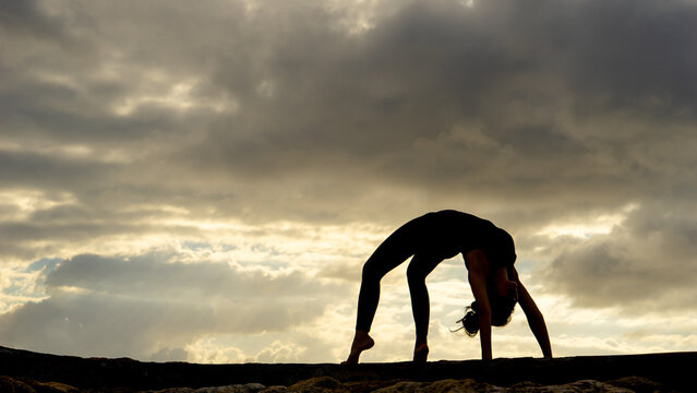 Silhouette of Woman Doing Wheel Pose Yoga Backbend at Sunset