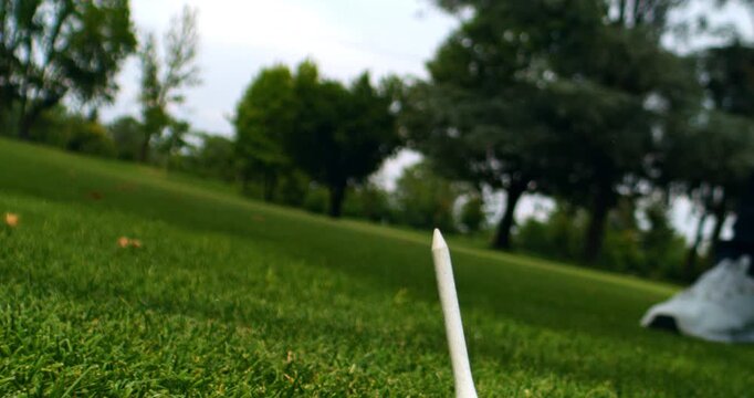 Super Slow Motion Extreme Close Up Of Driver Hitting Golf Ball. Power And Precision In Golf.Low-angle cinematic shot capturing the exact moment the golf driver strikes the ball, emphasizing speed.
