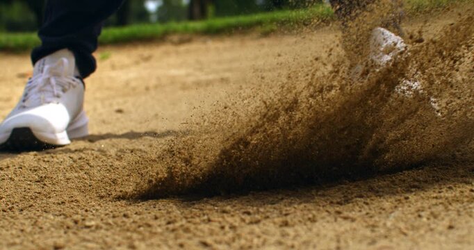 Super Slow Motion Close Up Of Sand Flying After Golf Bunker Shot. Concept Of Dynamic Sports Background. Abstract close-up of sand particles suspended in motion after a bunker shot.