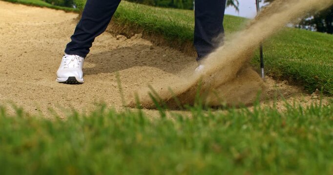 Super Slow Motion Of Golf Bunker Shot With Sand Explosion. Concept Of Precision Under Pressure. Dramatic slow motion footage of a golfer escaping the bunker as sand bursts into the air.
