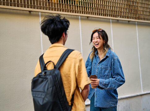 Portrait of a smiling couple in the city, tourists visiting destination, summer trip exploring, beautiful couple having fun outdoors