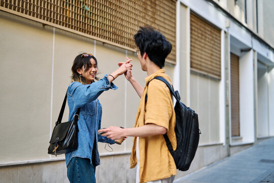 Portrait of a smiling couple in the city, tourists visiting destination, summer trip exploring, beautiful couple having fun outdoors